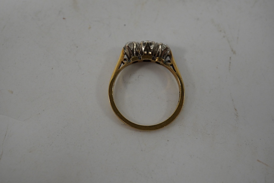 An 18ct gold and three stone diamond set ring, size K, gross weight 2.4 grams. Condition - fair to good